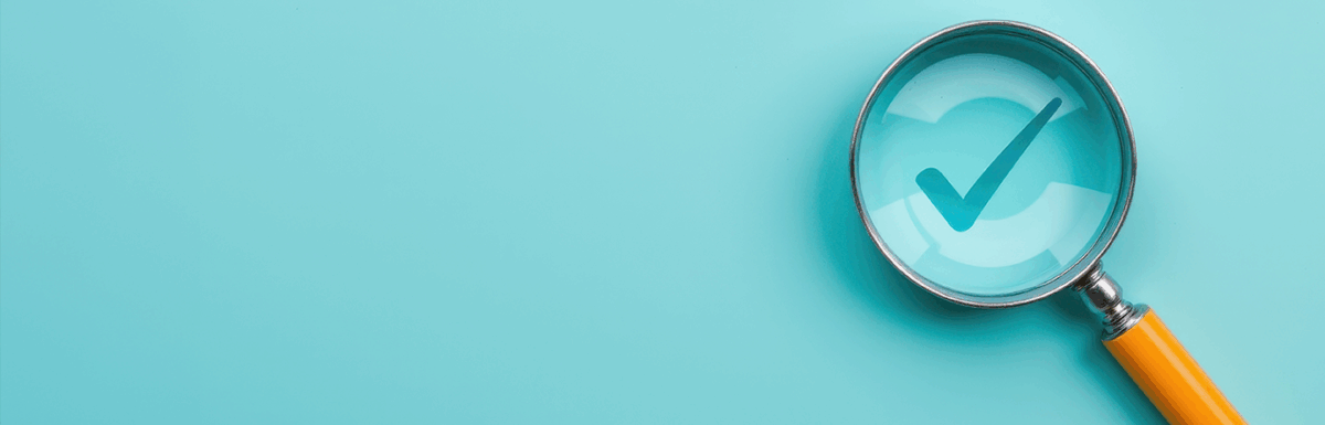 Checkbox under a magnifying glass on a black background