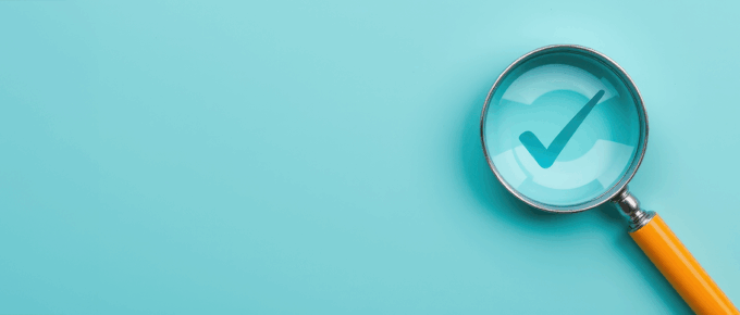 Checkbox under a magnifying glass on a black background